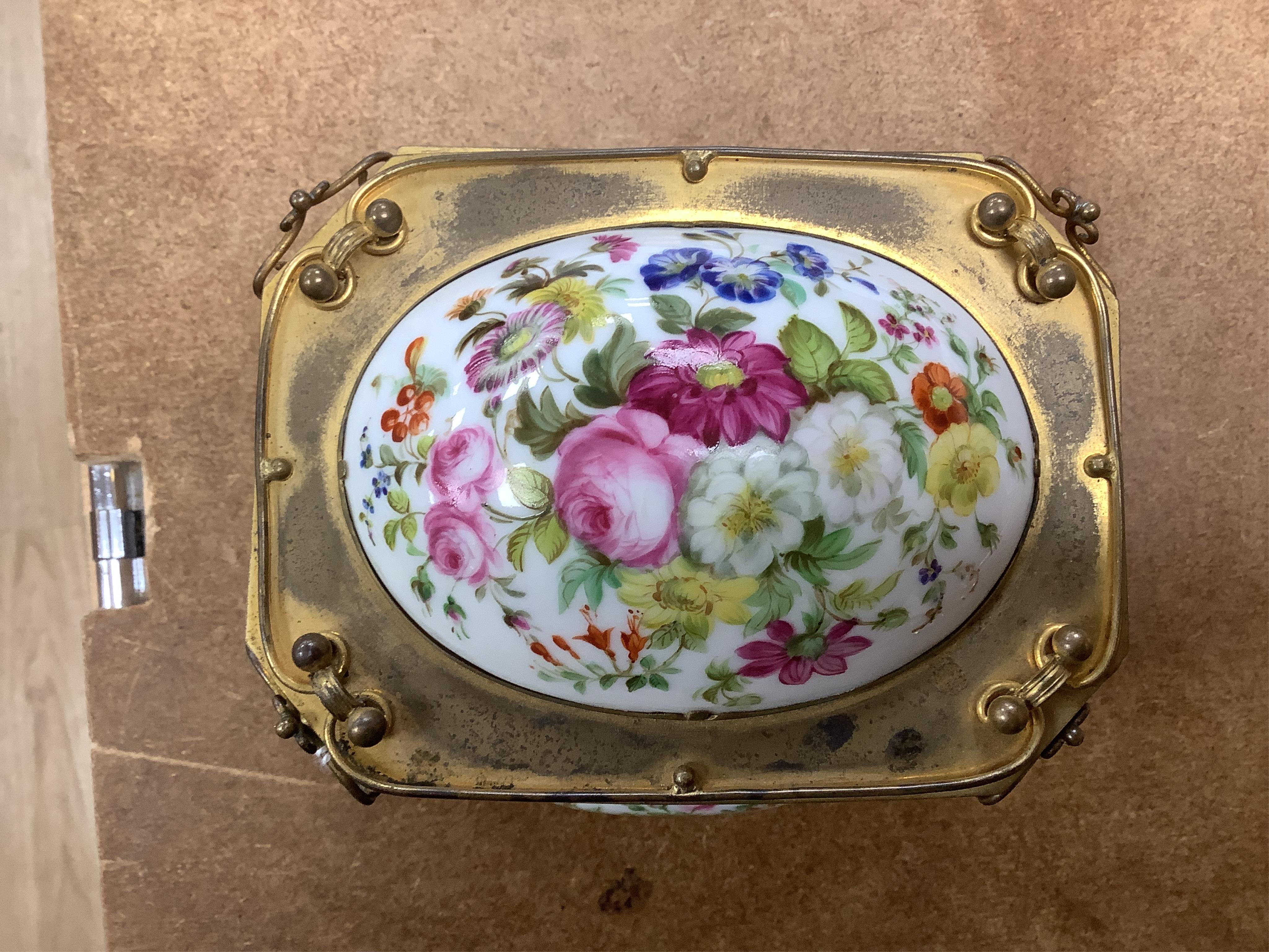 A gilt-brass figural and floral porcelain jewellery casket, 14cm wide, 11cm high.